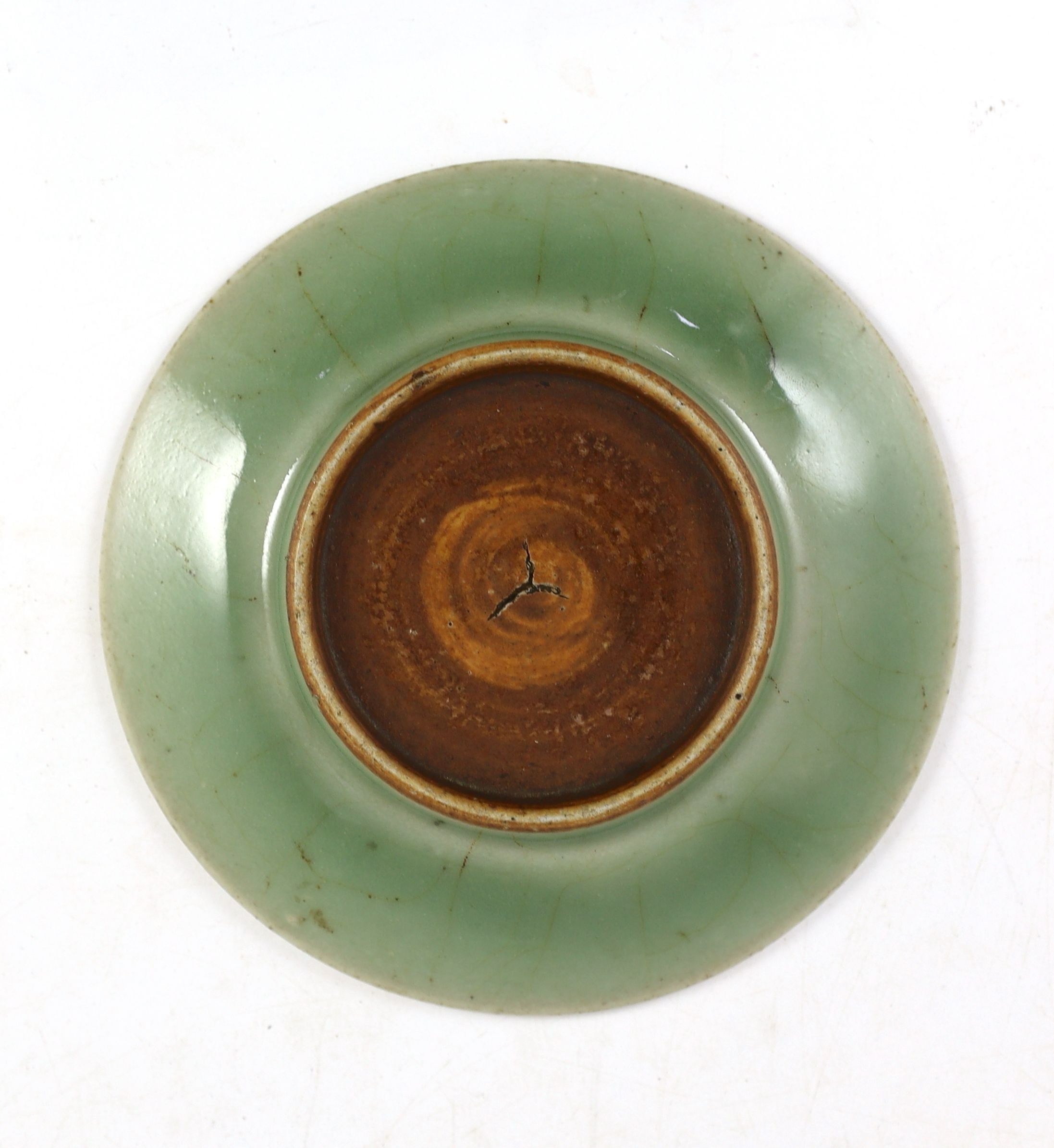 A Chinese celadon glazed small peony dish, Qing dynasty, 14.8cm diameter